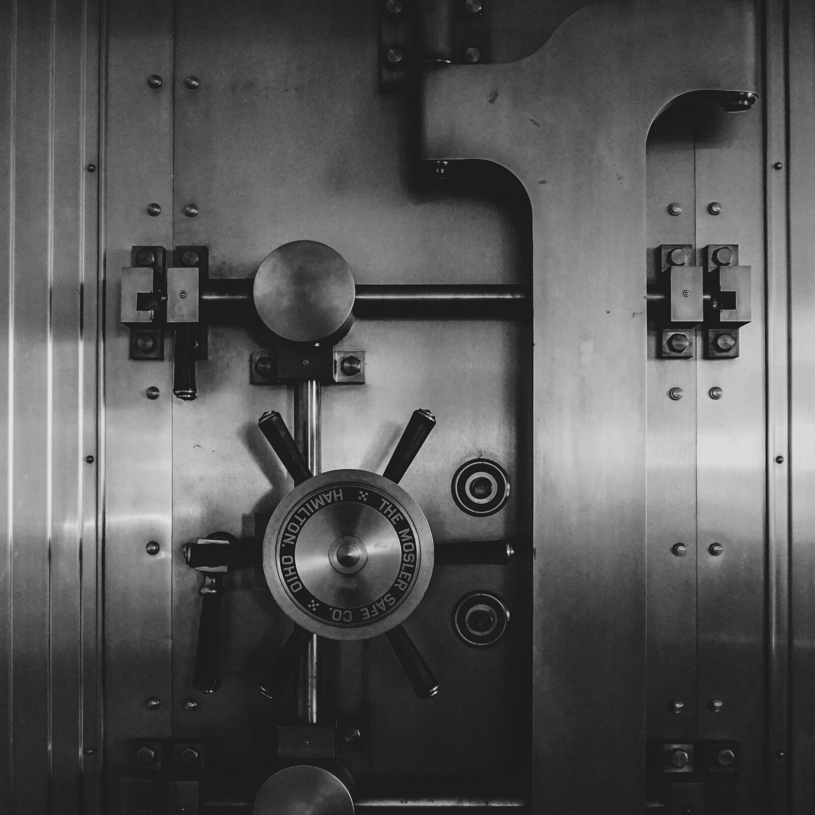 Black-and-white photo of a heavy bank vault door